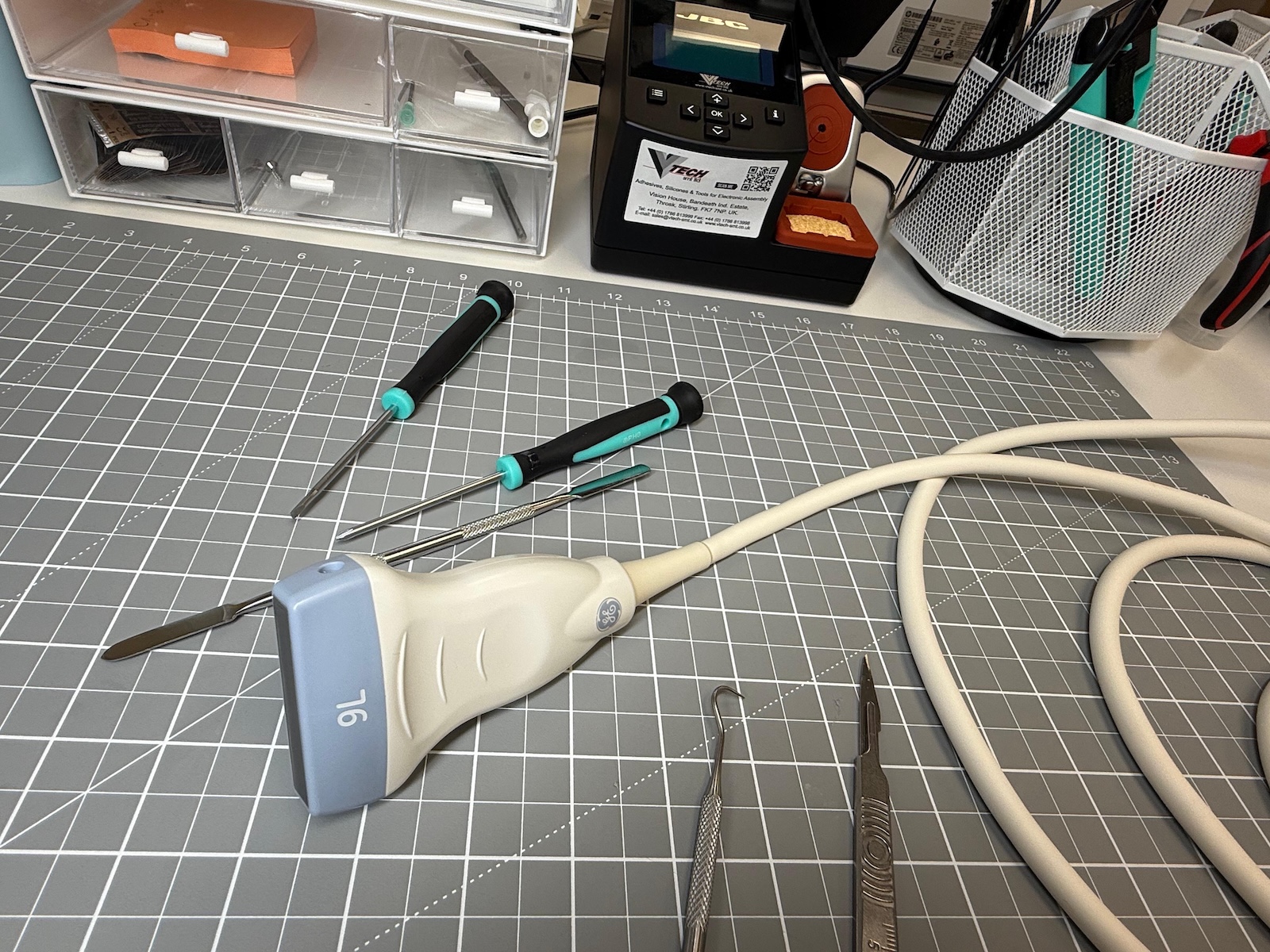 Professional ultrasound machine repairs. Ultrasound machine laying on a mat with tools ready for repair
